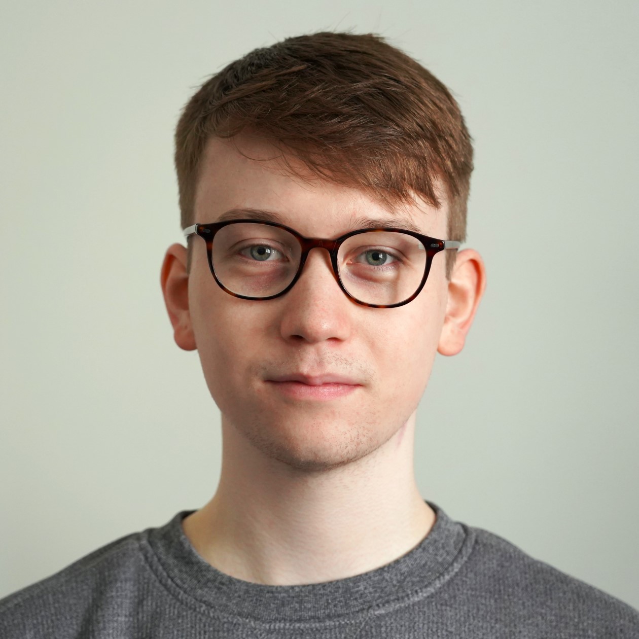 Gregor Soutar wearing glasses and a grey jumper.